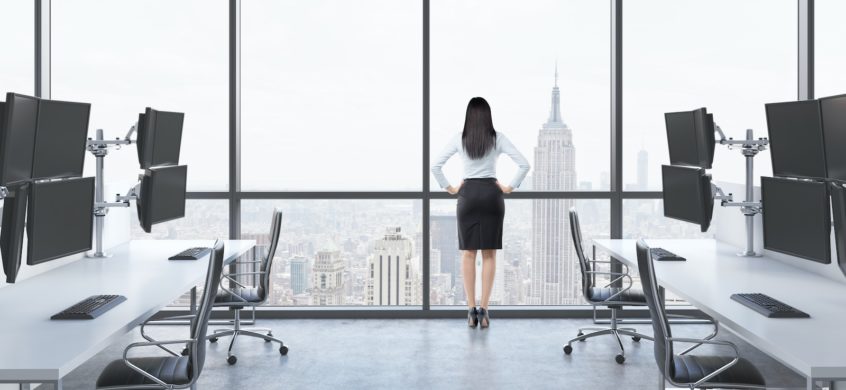 Businesswoman looking out the window visioning her new website and online marketing options